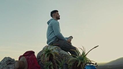 Canvas Print - Hiking, view of mountain and man drinking water, relax on outdoor adventure and freedom in nature. Trekking, rock climbing and hiker sitting with bottle, backpack and motivation to travel on blue sky