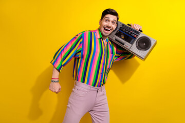 Poster - Photo of crazy man in vintage clothing enjoy hear favorite soundtracks from his childhood using boombox isolated on yellow color background