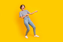 Full Body Profile Portrait Of Cheerful Impressed Lady Arms Pull Empty Space Rope Isolated On Yellow Color Background