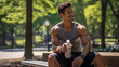 © Favio - muscular latin sporty man resting in a park, holding a bottle of water