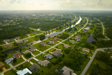 Wall Mural - Aerial landscape view of suburban private houses between green palm trees in Florida quiet rural area