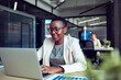 © Marko Geber - Smiling businesswoman working on laptop in office