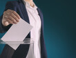 © New Africa - Woman putting her vote into ballot box on gradient color background, closeup. Space for text