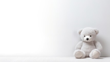 Sticker -  a white teddy bear sitting in front of a white wall with a blank space in the middle of the picture.