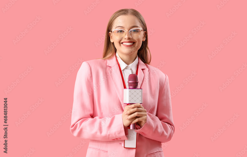 Female journalist with microphone on pink background