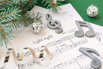 Wall Mural - Music note sheets with Christmas decor on green background