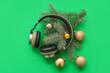 canvas print picture - Headphones with Christmas decor on green background