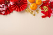 Infuse your Chinese New Year celebration with elegance using this picturesque arrangement. Top view of fans, Feng Shui trinkets, symbolic elements on pastel backdrop, leaving space for festive message