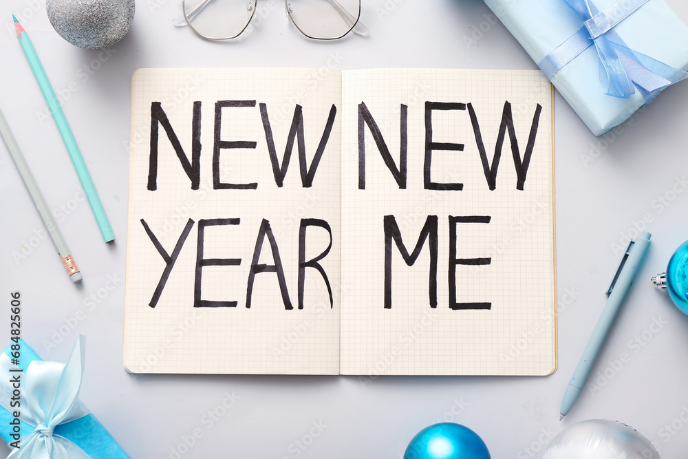 Notebook with text NEW YEAR NEW ME and Christmas decor on white background