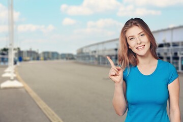 Canvas Print - Happy pretty student girl pointing finger