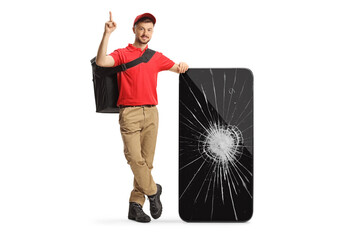 Wall Mural - Delivery man leaning on a smartphone with a broken screen and pointing up