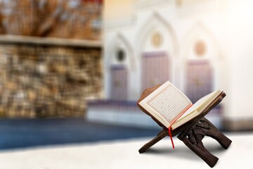 Wall Mural - reading Quran holy book Quran on wooden seating