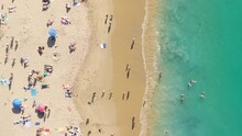 Top View Of People Swimming On Sandy Beach At Pacific Ocean, Laguna Beach, Orange County, California, USA. Drone Shot Of Tourists Enjoying Vacation At Summer. Crystal Green Water Of Ocean, 4k Footage