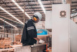 © SpaceOak - Woodworkers operate machines, tend lathes to cut, shape wood fixtures in manufacturing process