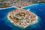 Fototapeta Desenie - Aerial view of Primosten old town on the islet, Dalmatia, Croatia. Primosten, Sibenik Knin County, Croatia. Resort town on the Adriatic coast. Aerial view of adriatic town Primosten, Croatia