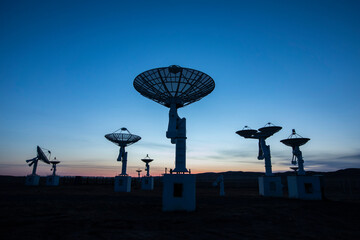 The silhouette of a radio telescope