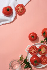 Wall Mural - Creative scene for advertising natural ingredient with tomato. Pink background with copy space. Tomatoes bring many health benefits, high nutritional content and help the body fight many diseases.