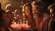 © Roman Ribaliov - A jubilant family celebrates around a cake with lit candles, sharing a moment of joy and togetherness