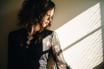 Wall Mural - Portrait of a beautiful sensual woman in a black lace and silk dress