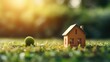 Eco friendly house on green nature bokeh background, Mini wooden house on green grass
