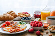 Breakfast buffet. Full english and continental. Large selection of brunch and breakfast food on the table with egg, bacon, toast, orange juice, croissant, coffee, fruits and nuts