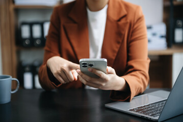 Businesswoman hand using laptop, tablet and smartphone in office. Digital marketing media mobile app and discussing plan new start up project. Finance task..