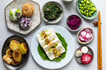 Wall Mural - Japanese lunch with silken tofu, onigiri, spinach gomae, miso leeks ad pickled vegetables