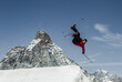 © ADDICTIVE STOCK - Anonymous carefree man skiing and jumping on snowy mountain while enjoying winter day at Swiss Alps