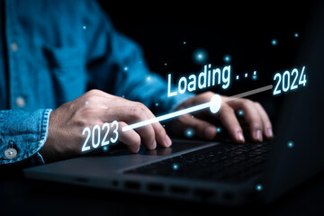 Wall Mural - Businessman using laptop computer with downloading tool bar for countdown 2023 to 2024 , Merry Christmas and happy new year preparation by technology concept.