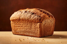 A loaf of rye bread, close up. Brown background.