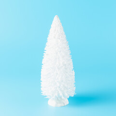 Wall Mural - White Christmas tree on blue background. Minimal New Year concept.