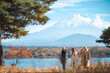 © chokniti - Happy tourist traveler woman or man enjoying on lake kawaguchiko with mount fuji in japan, spring and summer, Japan travel vacation site