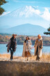 © chokniti - Happy tourist traveler woman or man enjoying on lake kawaguchiko with mount fuji in japan, spring and summer, Japan travel vacation site