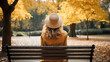 © NooPaew - Back view of a young woman sitting on a bench in the park at autumn.