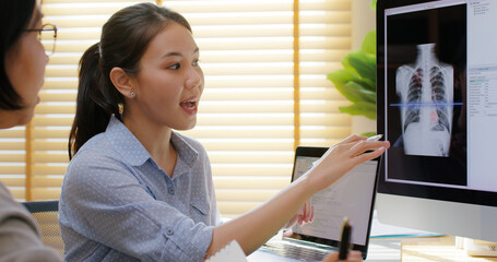 Big data AI coding screen for asian future health care smart tech IT solution. Asia team woman people code analyst job work on science project Lung X-ray scanner medtech tools meeting talk at office.