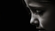 © Kiss - Close up portrait of a young child in contemplation with dramatic lighting and black background