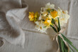 © RooM The Agency - Overhead view of a bunch of daffodils on a  linen tablecloth