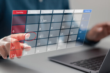 Wall Mural - Time management concept. Businessman using laptop and manages time on calendar virtual screen interface. Highlight appointment reminders and meeting agenda on the calendar.