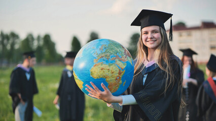Wall Mural - A graduate student poses with a globe in front of her friends.