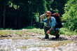 © Drazen - Young hiker drinks water from mountain creek.