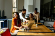 © BGStock72 - Business woman working on laptop with her young multiethnic startup team working in the modern office