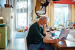 © Marko Geber - Stressed senior man reading bank statement at home