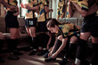 Female soccer players in focused preparation inside the locker room