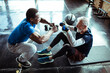 © Davor - Smiling senior man working out with assistance of personal trainer at gym