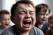 Little boy crying while being bullied by his schoolmates
