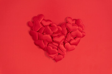 Wall Mural - Valentine's Day concept. valentines, red hearts confetti on red background. Flat lay, top view, copy space