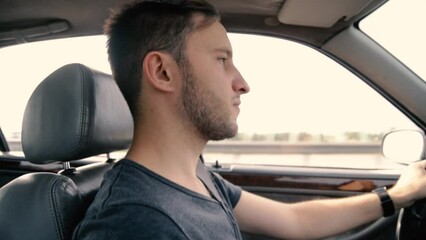 Wall Mural - young handsome male car driver driving