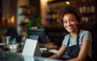 © Malchevska Studio - Dark-skined cheerfull woman working as a cashier in the store