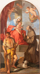 VICENZA, ITALY - NOVEMBER 5, 2023: The painting  of Madonna with the st. John the Baptist and St. Anthony of Padua by Giulio Carpioni (1650).