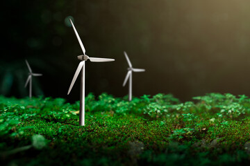 Wind turbines that are in harmony with nature With the forest as the background, concept of using clean energy, campaigning for the use of renewable energy that is environmentally friendly.